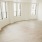 Spacious living room with bright lighting and wood-like flooring
