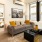 Spacious and well lit living room with wood floors and an open floor plan with access to the kitchen.