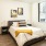 Spacious and well lit bedroom with wood floors and large windows