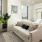 Spacious and well lit living room with wood floors and an open floor plan with access to the kitchen.