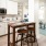 Spacious and well lit kitchen with wood floors and stainless steel appliances. 