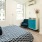 Spacious and well lit bedroom with plush carpet and large windows