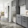 Spacious and well lit kitchen with wood floors and stainless steel appliances. 