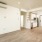 Spacious and well lit living room with wood floors and an open floor plan with access to the kitchen.