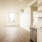 Spacious and well lit living room with wood floors and an open floor plan with access to the kitchen.